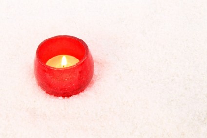 Rote Kerze im Schnee