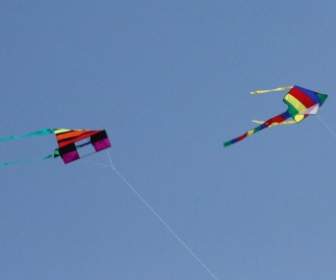 Two Colorful Kites Flying Overhead